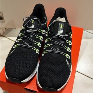 Nike Quest 2 black and white iron green sneakers.